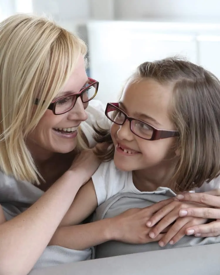 Kind mit optischen Kinderbrille und Ihrer Mutter beim Optiker